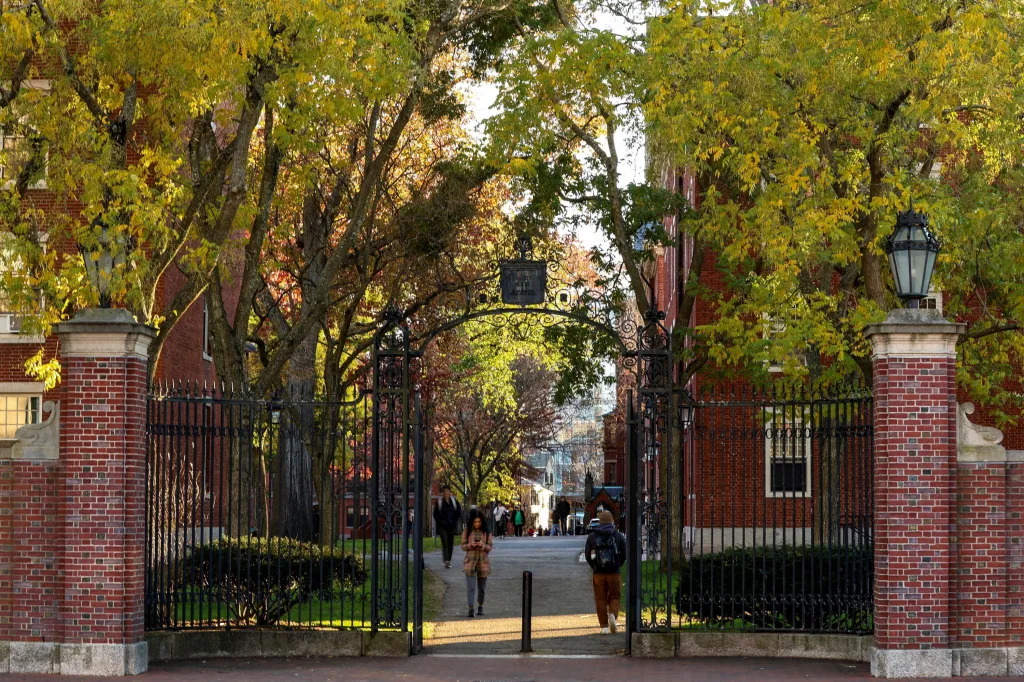 Students walk on campus at Harvard University, which is opening a probe into individuals mentioned in the Jeffrey Epstein files.