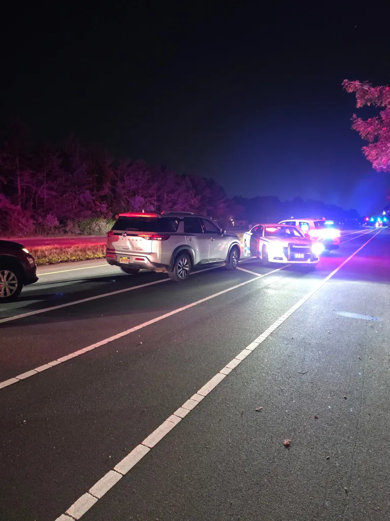 Police vehicles with flashing lights at the scene of a street takeover.