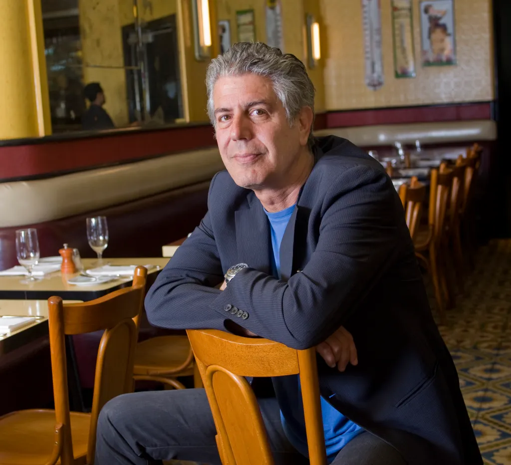 Anthony Bourdain, chef and author, sitting in Cafe D'Alsace.