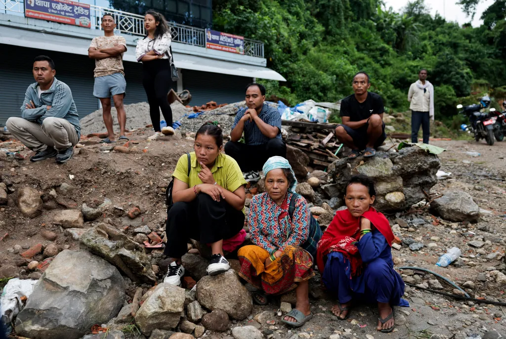 Survivors sit on debris following devastating floods in Trishuli, Nuwakot District, Nepal.