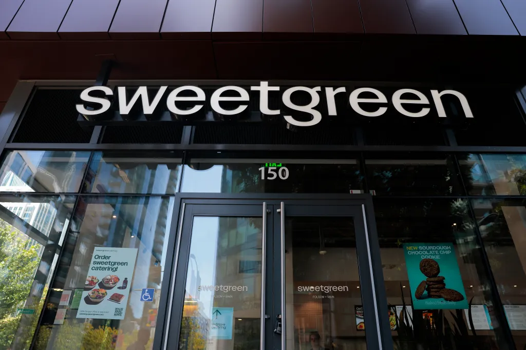 A Sweetgreen restaurant exterior with its logo and glass windows.