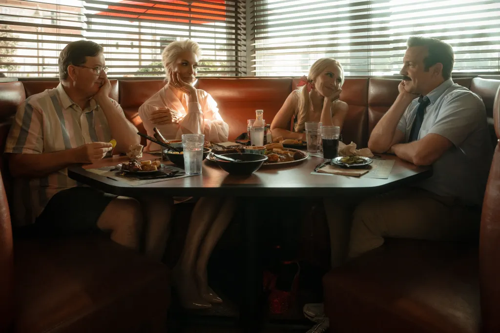 The cast of Ted Lasso enjoying a meal in a diner.