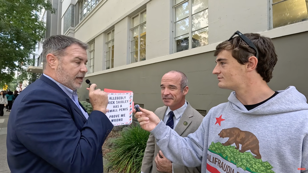 Terry Schanz holding a sign that reads 