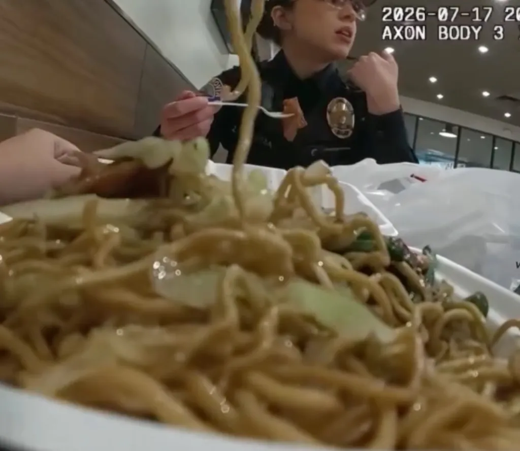 Monrovia Police Department officer eating a meal of noodles and cabbage from a styrofoam container.