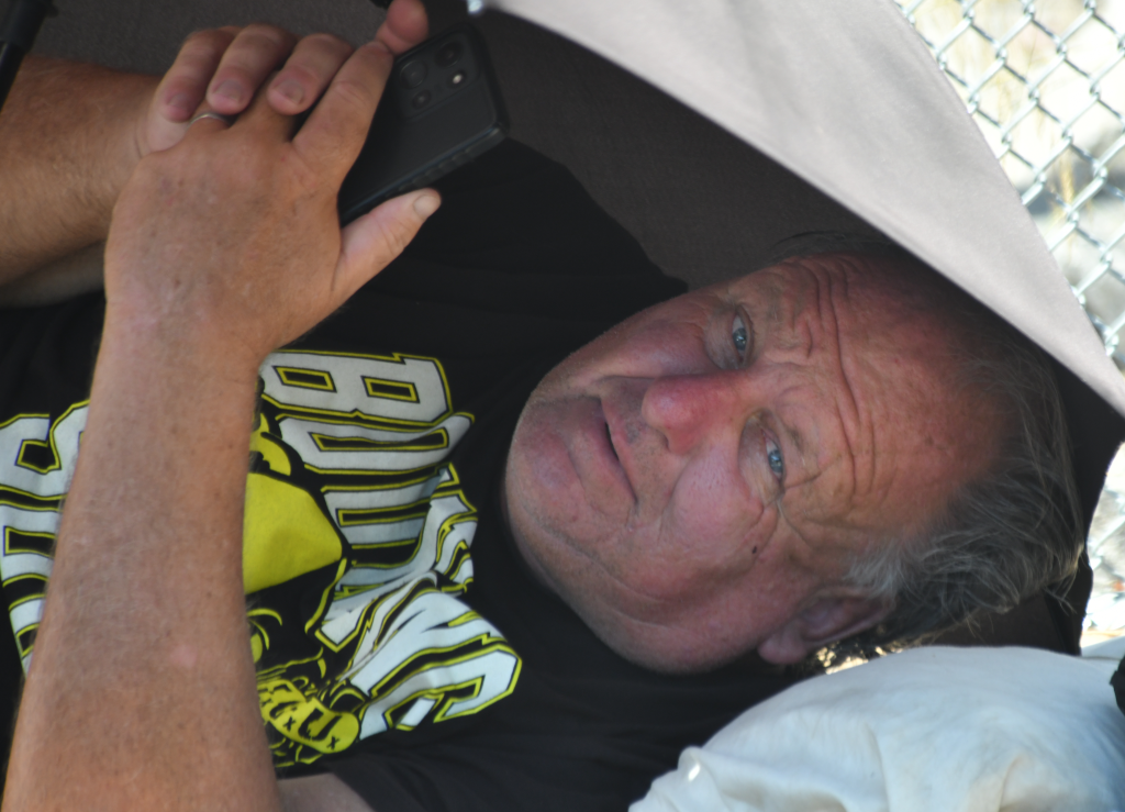 Tim Roller, a homeless man, rests at his encampment in Los Angeles.