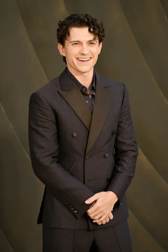 Tom Holland smiling at the world premiere of 