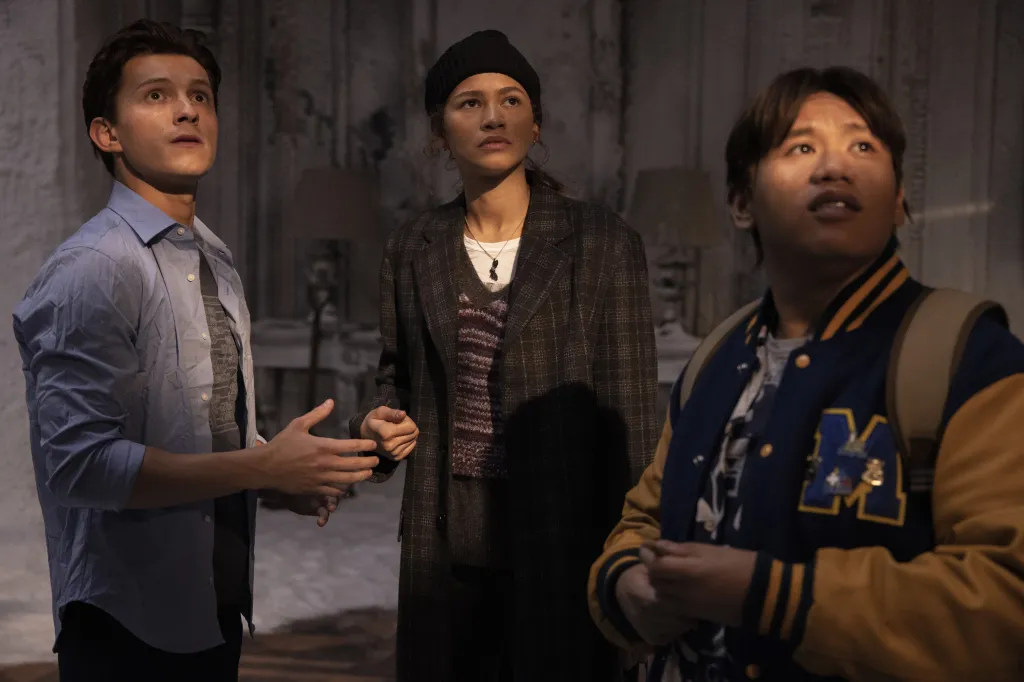 Tom Holland, Zendaya, and Jacob Batalon looking up in Spider-Man: No Way Home.