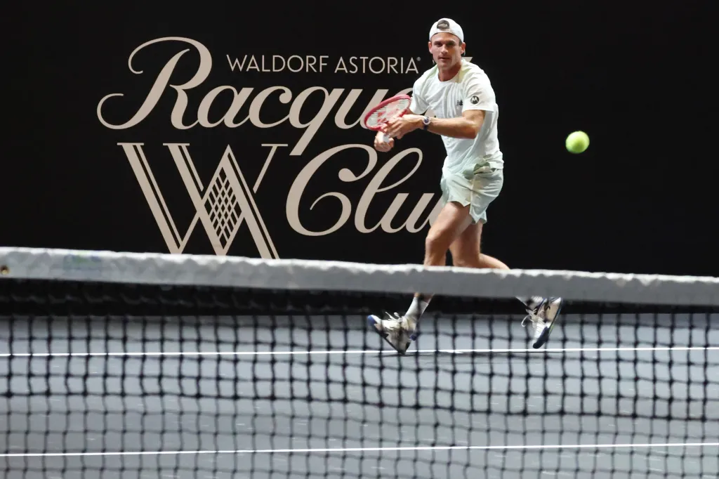 Tommy Paul hits a tennis ball during a match at the Waldorf Astoria New York Ballroom Tennis Invitational.