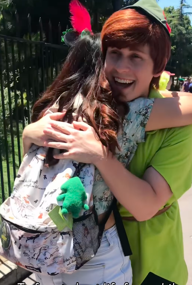 Toni Kulusich hugging someone dressed as Peter Pan.