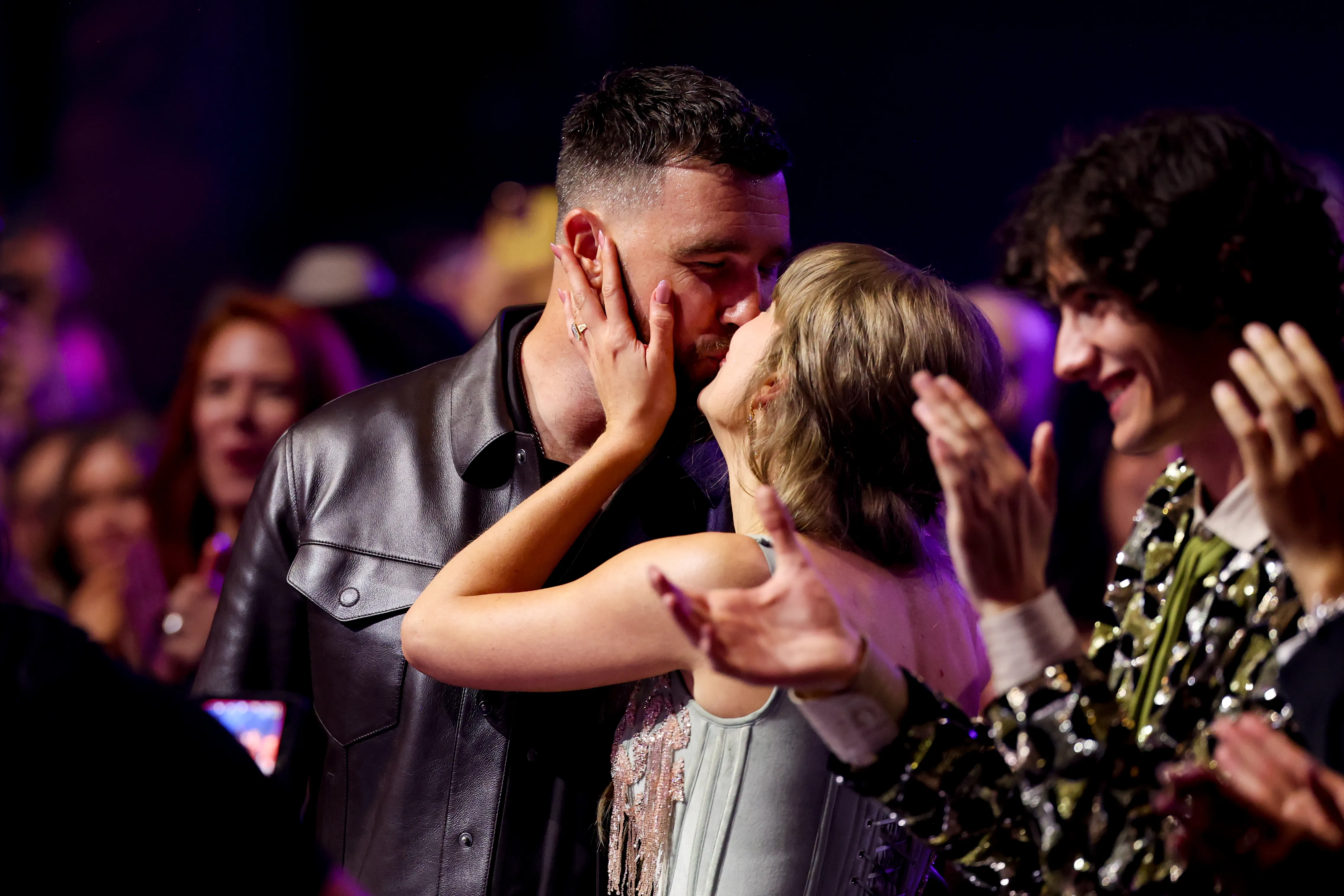 Travis Kelce and Taylor Swift share a kiss at the 2026 iHeartRadio Music Awards.