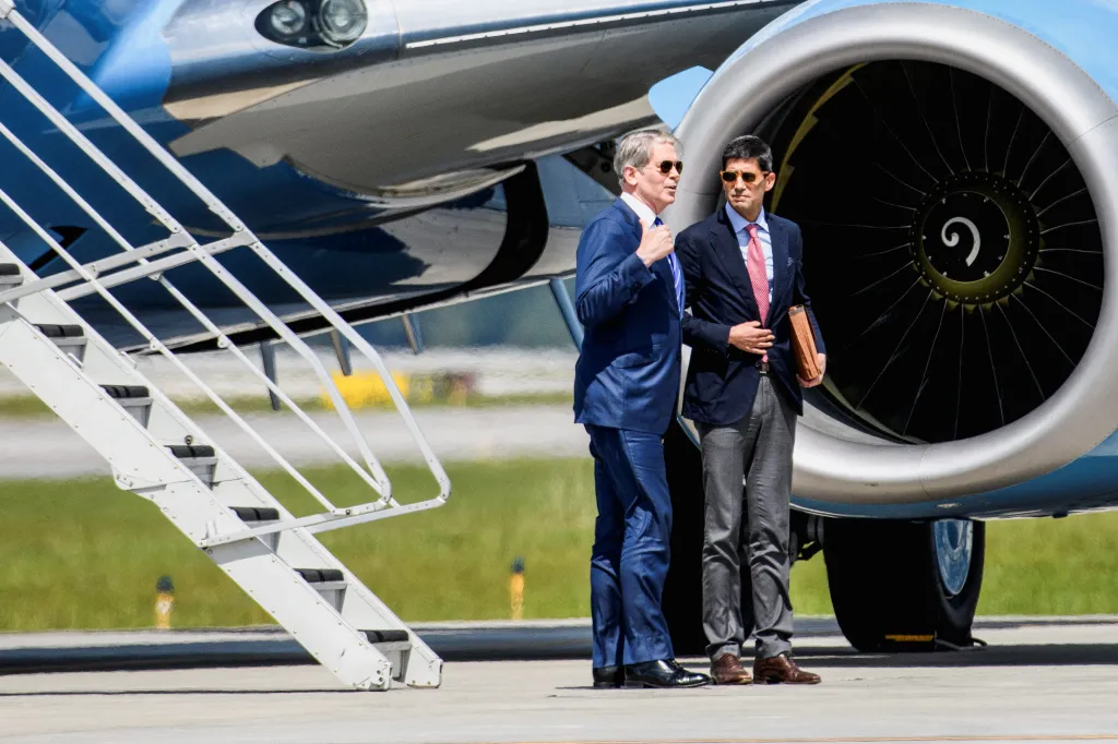 Treasury Secretary Scott Bessent and Federal Reserve Chair Kevin Warsh talking near an airplane prior to a G20 meeting.