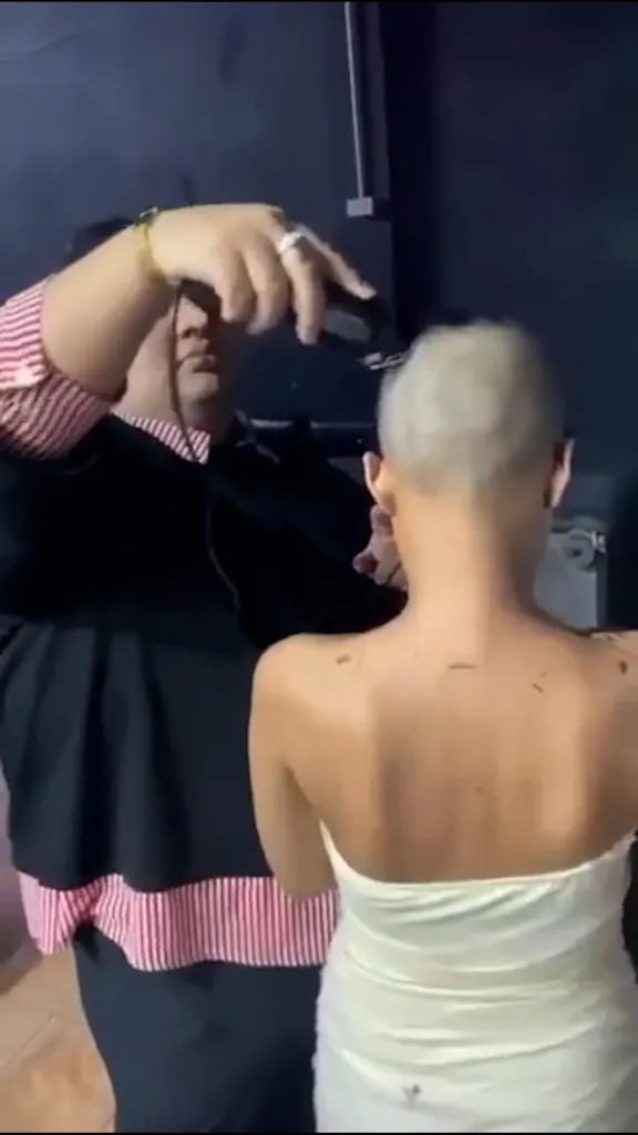 A barman shaves the head of a customer who tried to drink and dash.