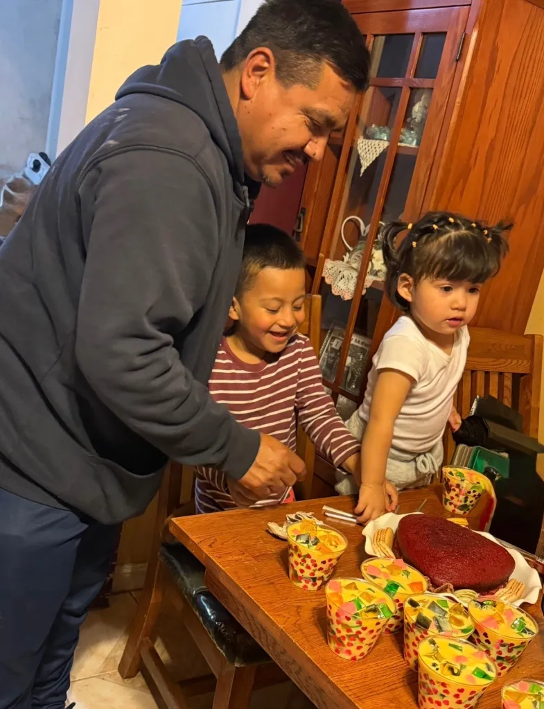 A father, son, and daughter celebrating with jello and cake.