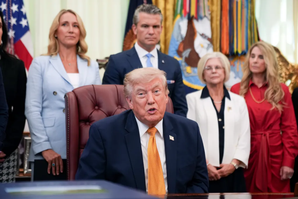 President Trump, Hegseth and Jennifer Rauchet are pictured as Trump announces and signs an executive order establishing the Presidential Military Spouse Commission in the Oval Office at the White House in Washington, DC on Tuesday, Aug. 4, 2026.