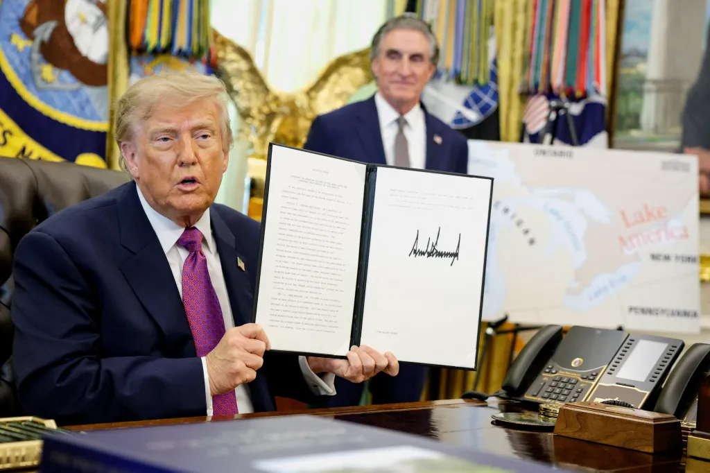 President Donald Trump holds up an executive order to rename Lake Ontario as Lake America after signing it in the Oval Office of the White House on, Aug. 27, 2026.