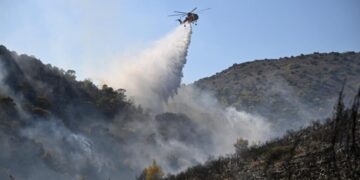 Firefighters battle massive wildfires in Belgium and Greece as 2 die on an island near Athens