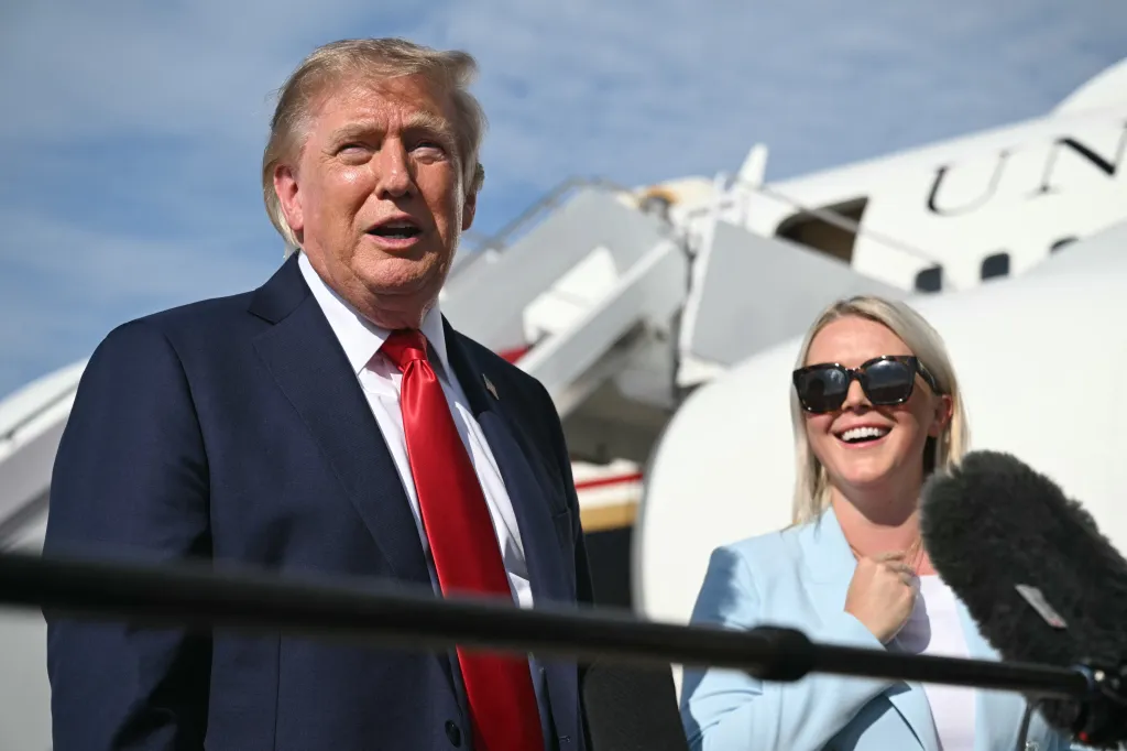 US President Donald Trump speaking to reporters, flanked by White House Press Secretary Karoline Leavitt.