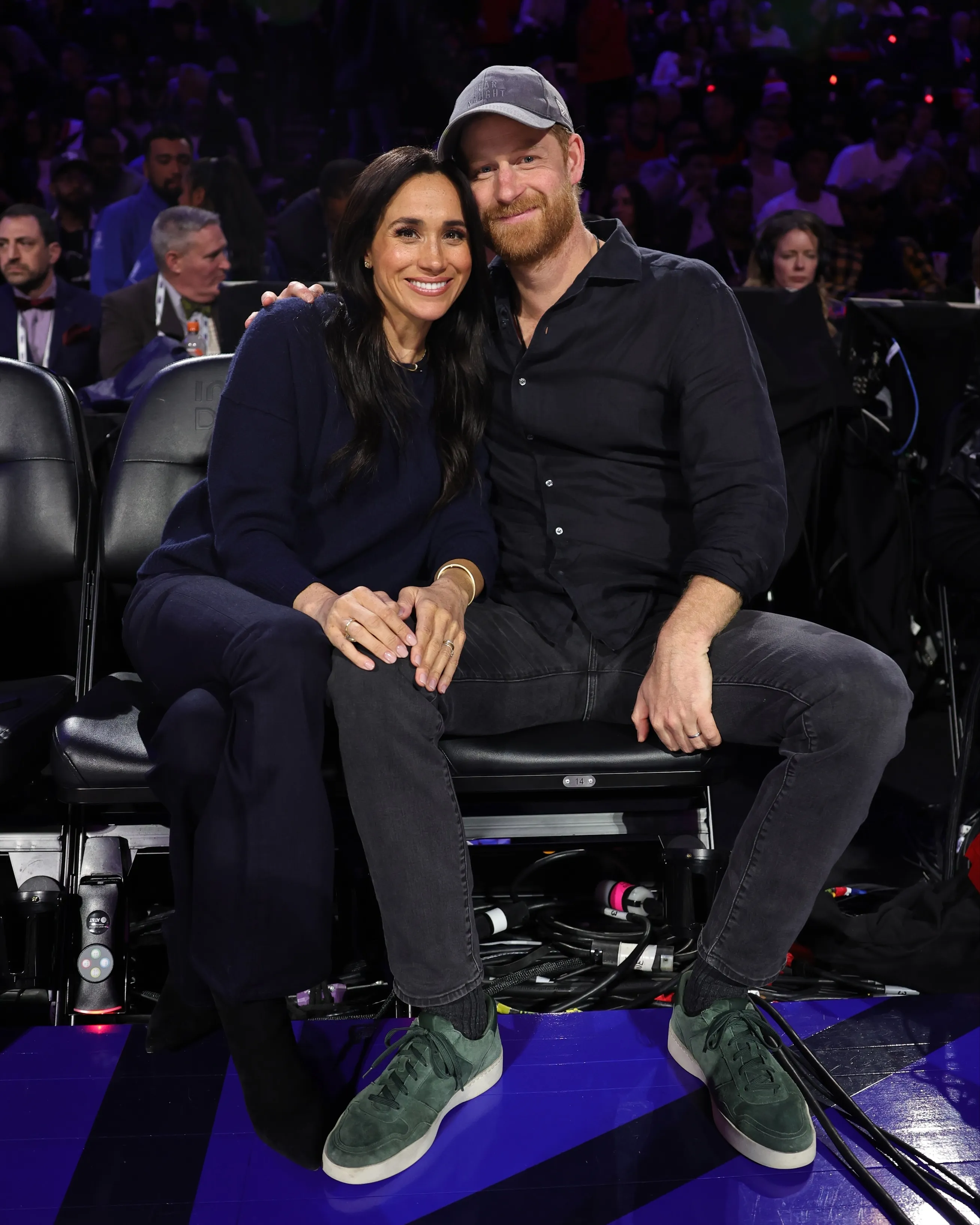 Meghan Markle and Prince Harry smiling and posing at the 75th NBA All-Star Game.