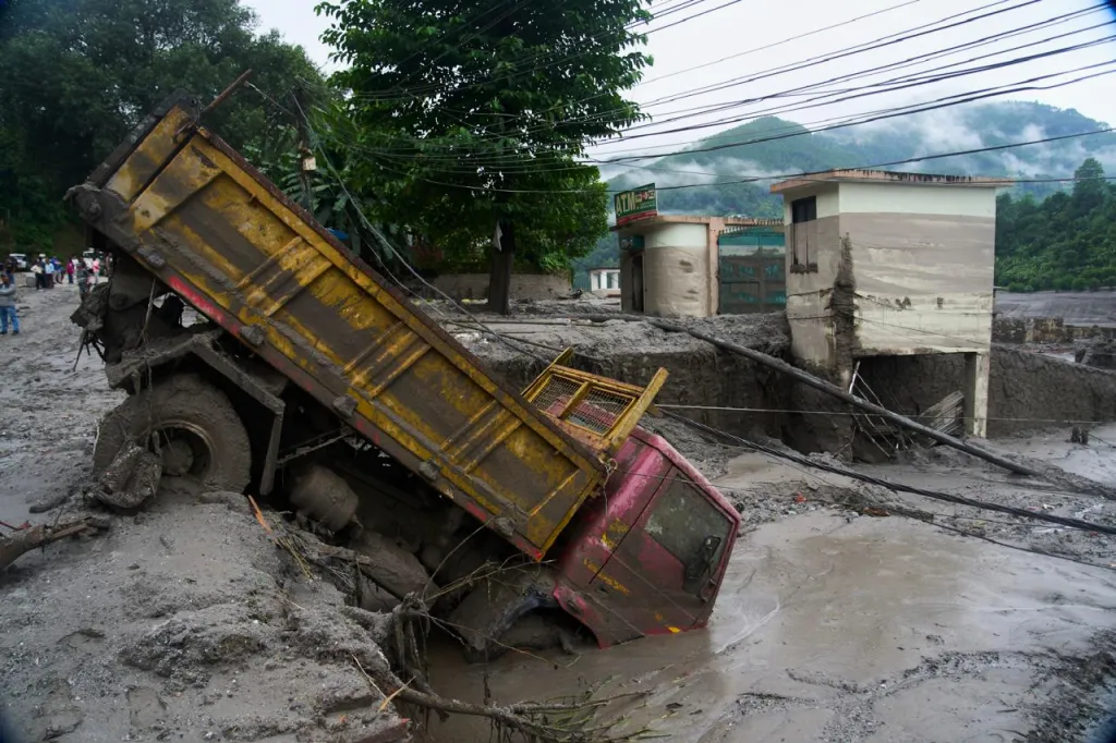 A vehicle caught in the aftermath of flash floods in Devighat, Nepal.