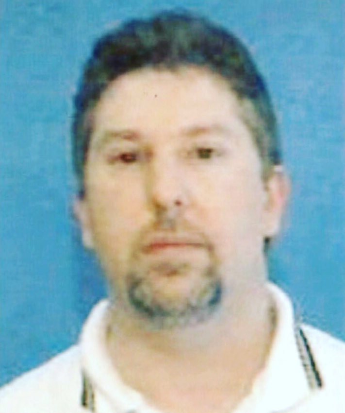 Richard Evonitz in a mugshot against a blue background.