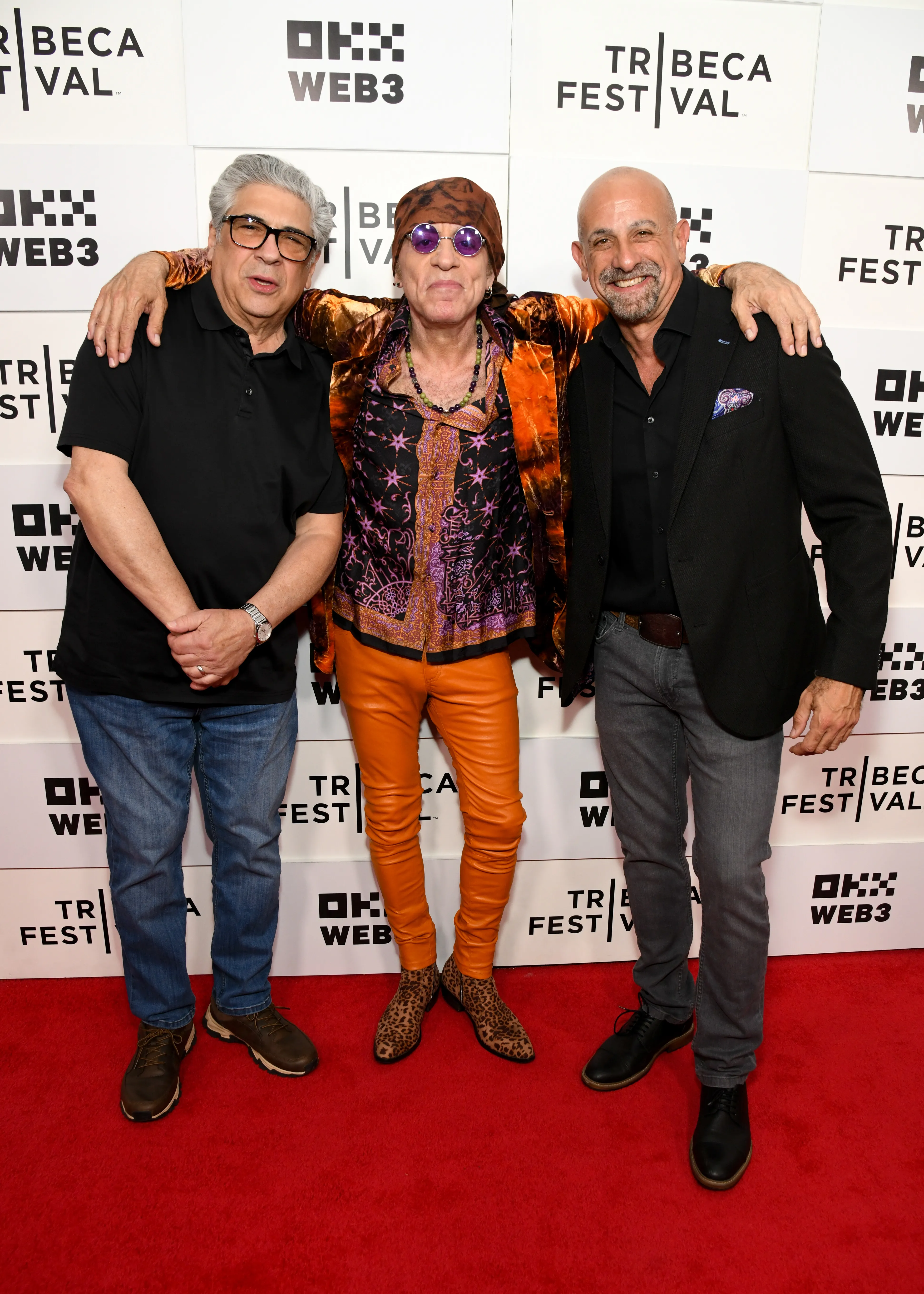 Vincent Pastore, Steven Van Zandt, and Bill Teck posing together on a red carpet.