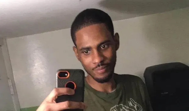 Tayvon Shuler holding up a phone to take a selfie.