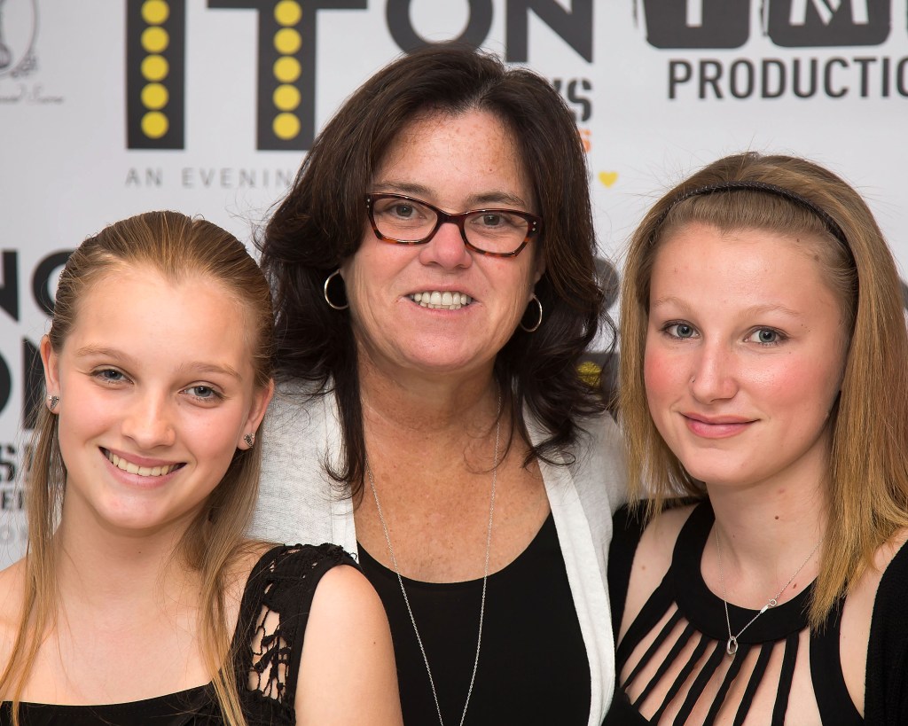 Rosie O'Donnell and her daughters, Vivienne Rose O'Donnell and Chelsea Belle O'Donnell, pose at an event.