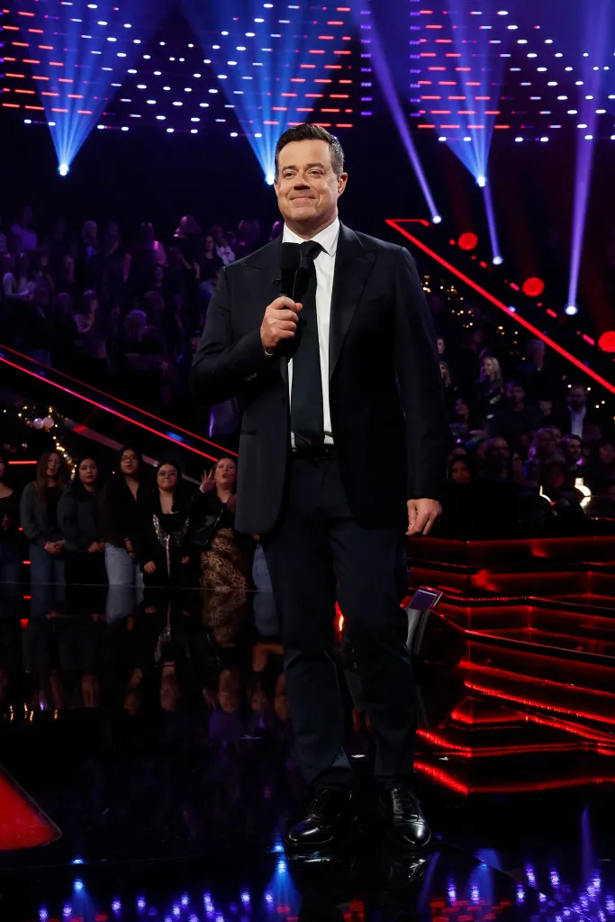 Carson Daly holding a microphone on 