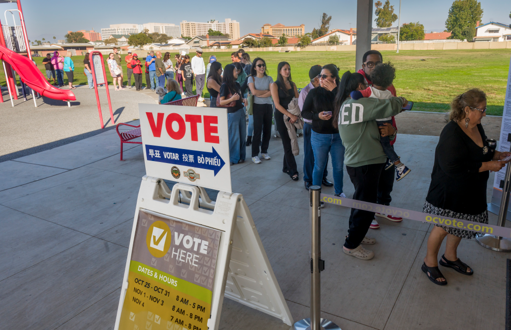 Voters stand in long lines to cast their ballots in the Proposition 50 special election on redistricting at the West Haven Park voting center in Garden Grove.