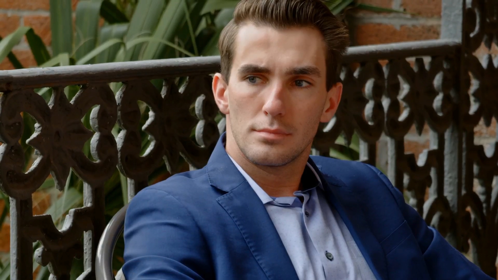 Debby's son from 90 Day Fiancé, in a blue blazer and light blue shirt, looks to the right.