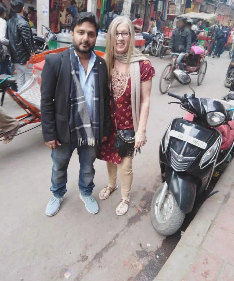 Jenny and Sumit standing together on a street in India.
