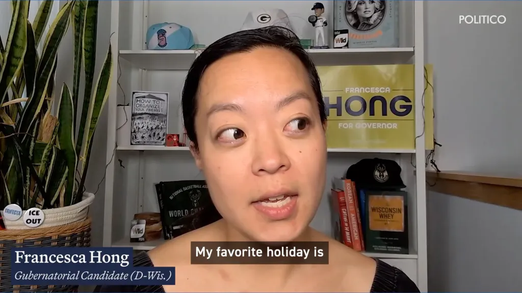 Francesca Hong, a Gubernatorial Candidate for Wisconsin, speaking with a political campaign sign in the background.
