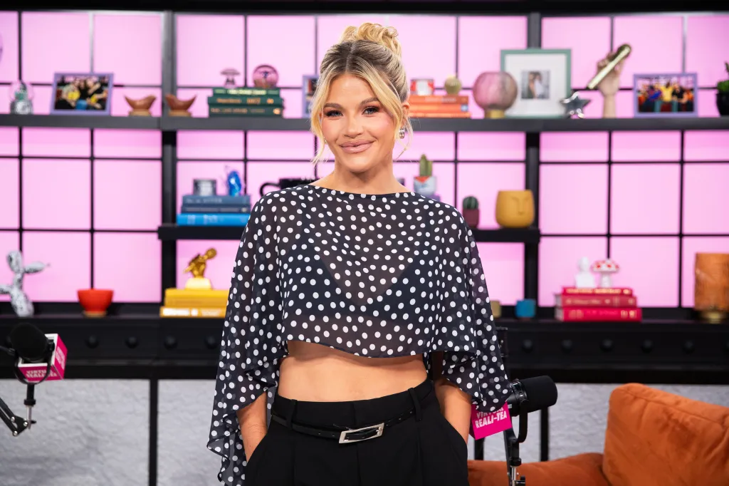 Witney Carson posing in a black and white polka dot top.