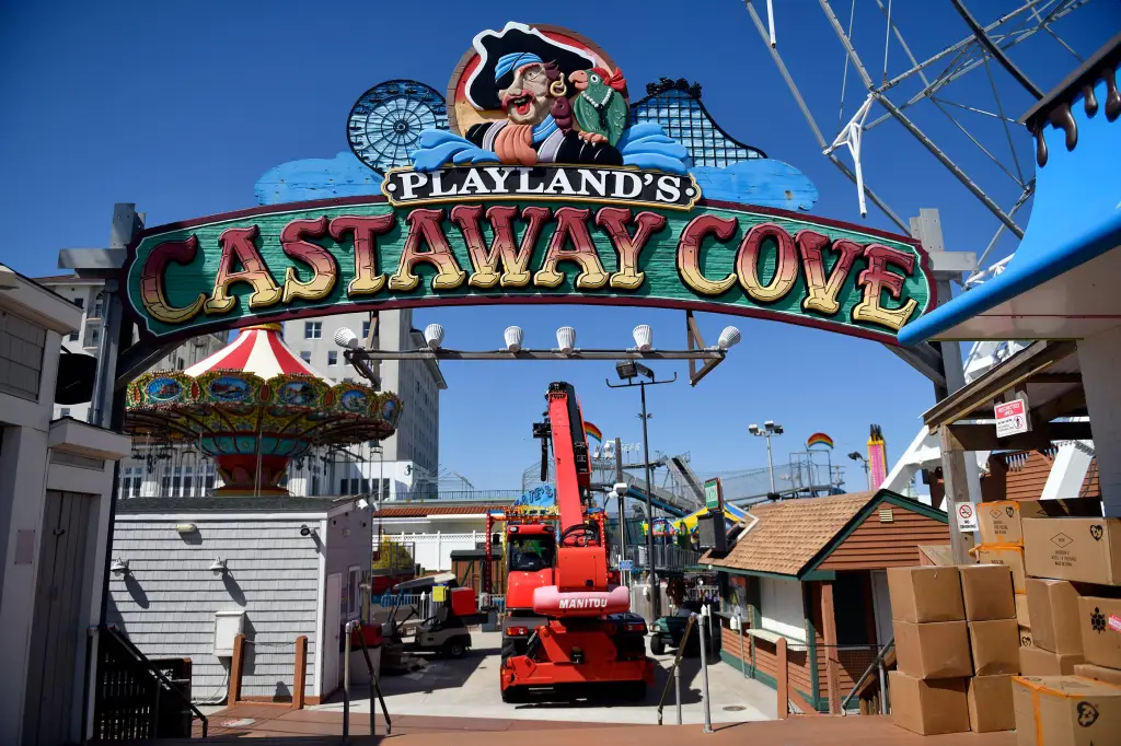 Workers prepare Playland's Castaway Cove on the Ocean City Boardwalk for opening after a four-alarm fire.