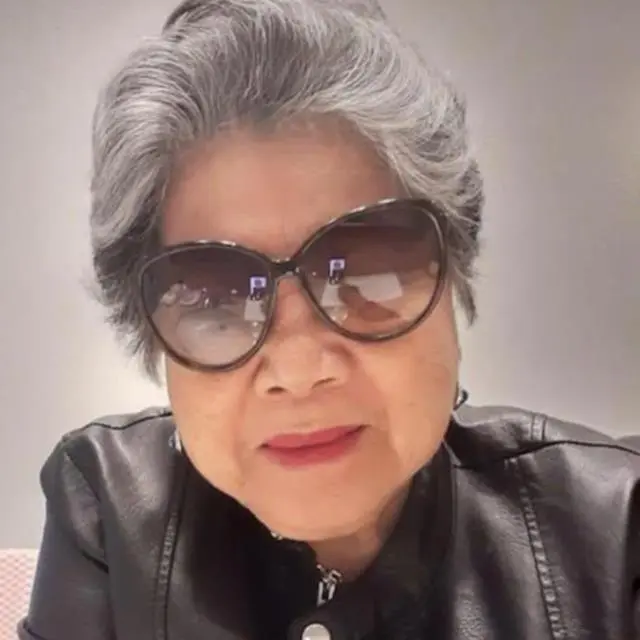 Mary Rivera wearing sunglasses and a black leather jacket.