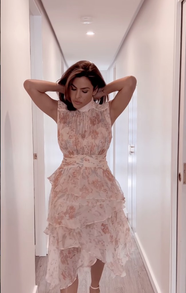 Eva Mendes in a floral-patterned, tiered ruffle dress.