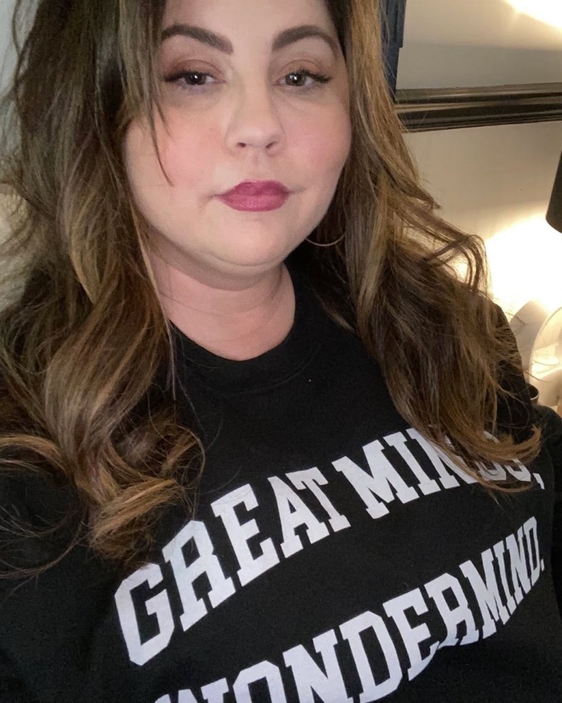 Mandy Teefey wearing a black sweatshirt that reads 