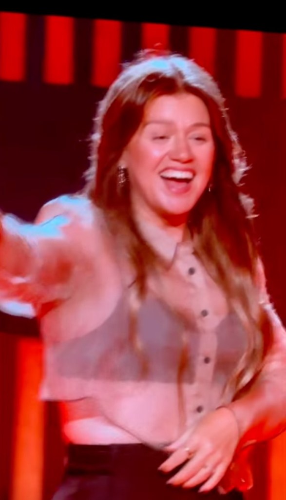 Kelly Clarkson performing in Las Vegas, smiling and looking to the right.