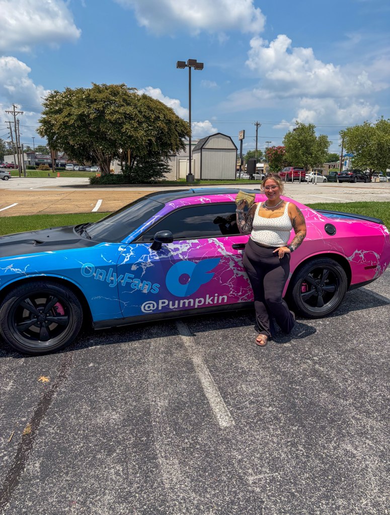A woman holding a stack of money next to a car with 
