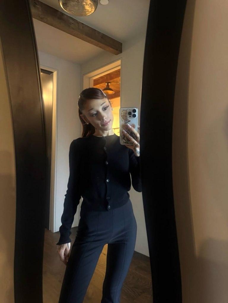 Ariana Grande taking a mirror selfie.