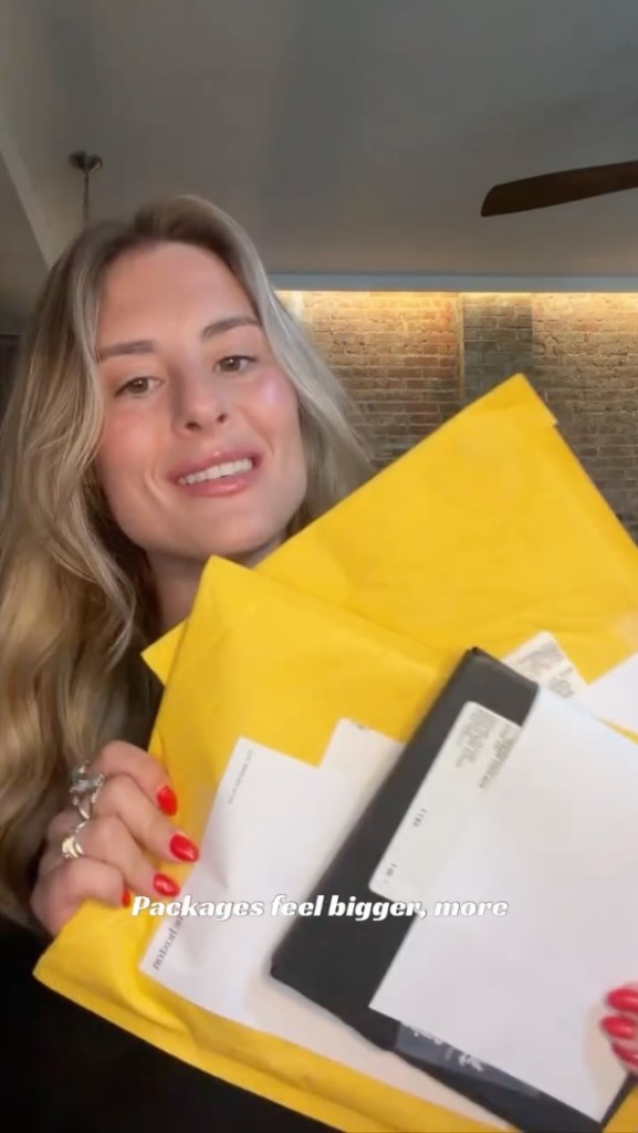 Taylor Palmby holding a stack of packages.