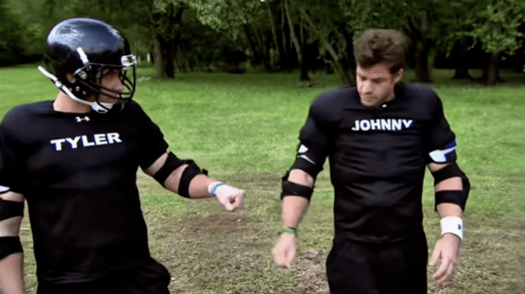 Tyler Duckworth and Johnny Bananas in athletic gear, with Tyler wearing a football helmet and Johnny wearing elbow pads.