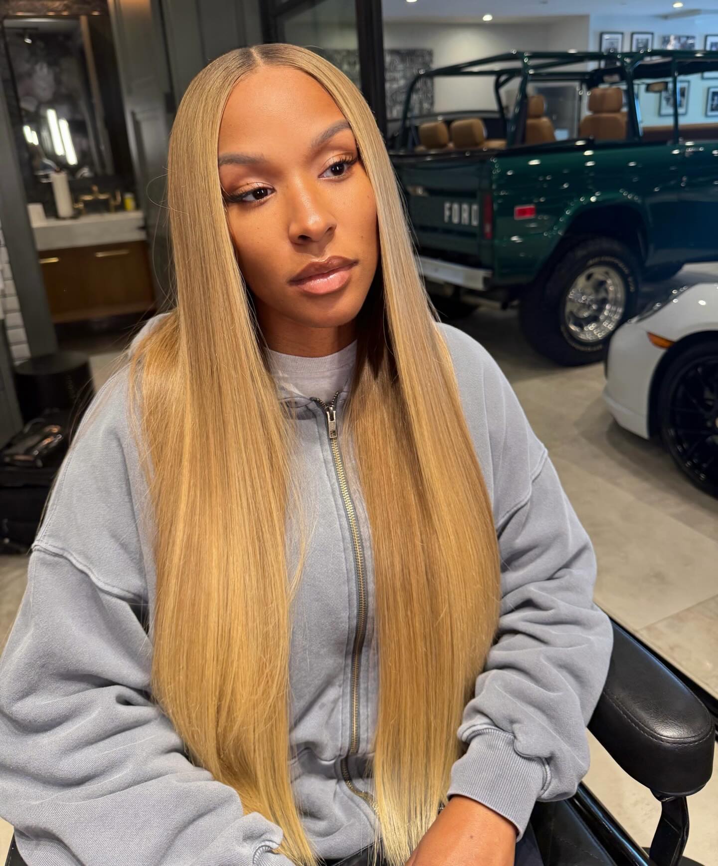 Savannah James with long, blonde hair and a gray hoodie.