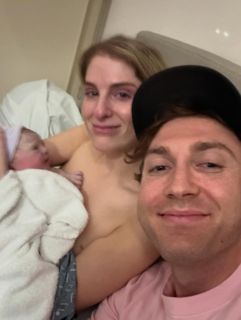Meghan Trainor and her husband Daryl Sabara hold their newborn baby.