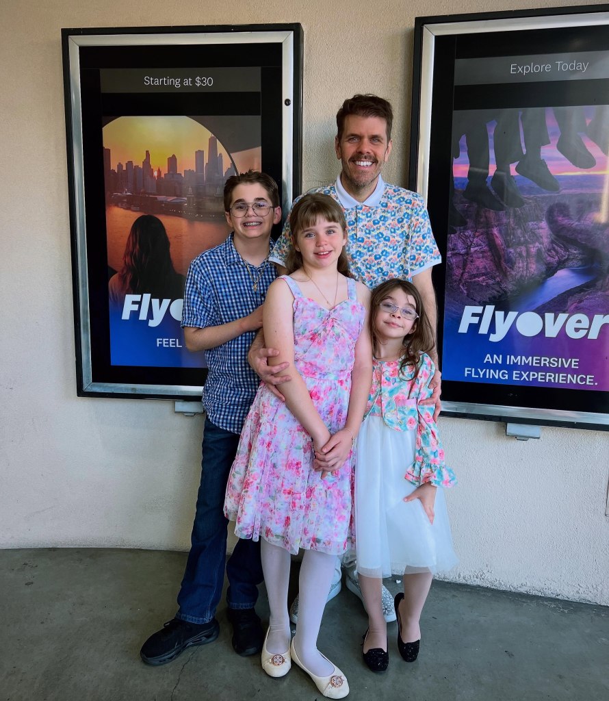 Perez Hilton poses with his three children in front of 