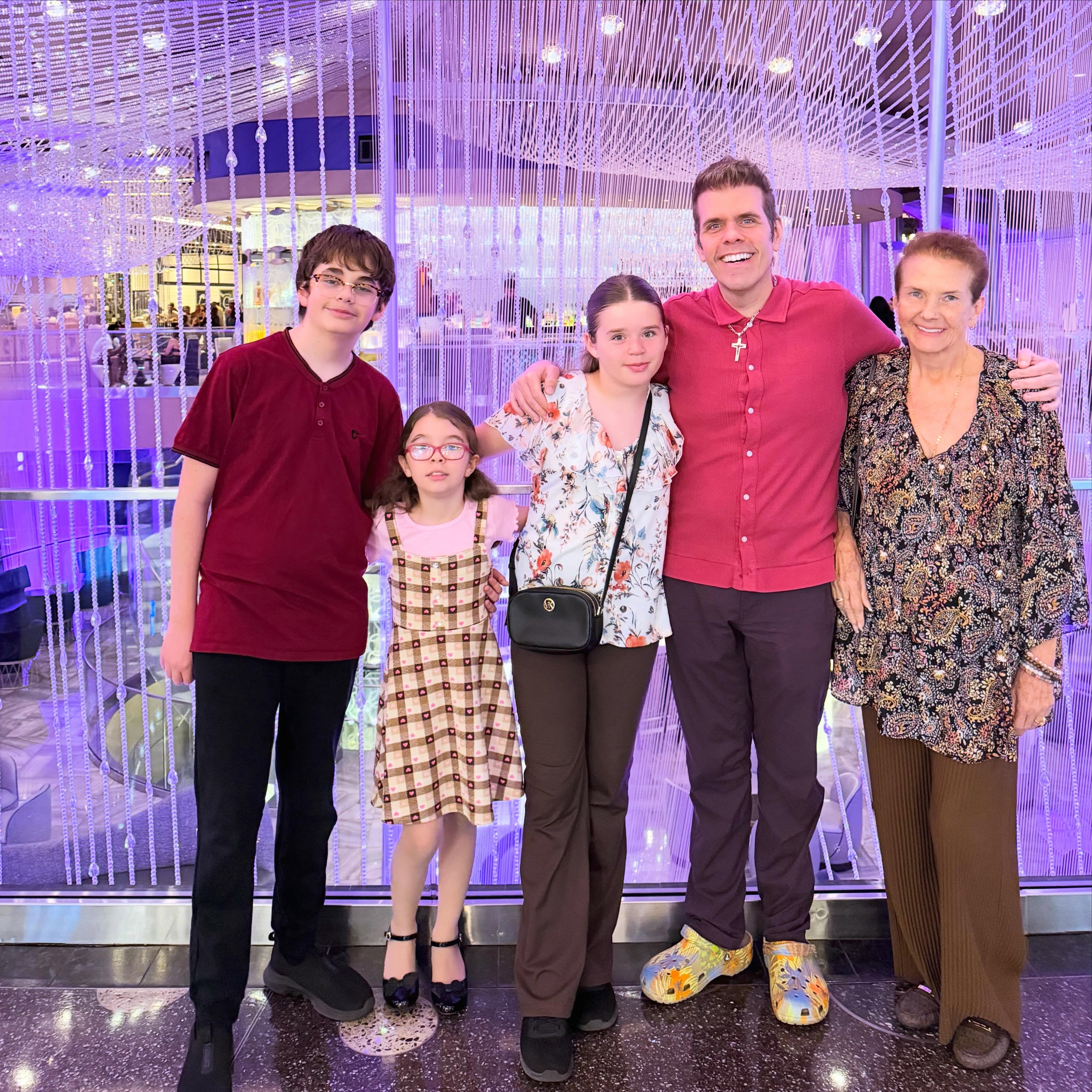 Perez Hilton, his mother Teresita Lavandeira, and his three children posing for a photo.