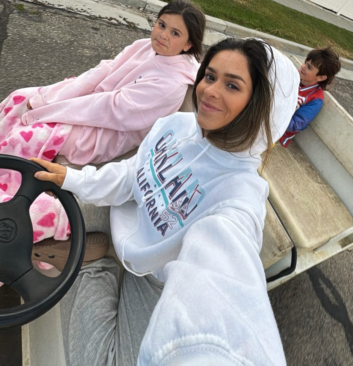 Taylor Frankie Paul with her kids, Indy and Ocean, in a golf cart.