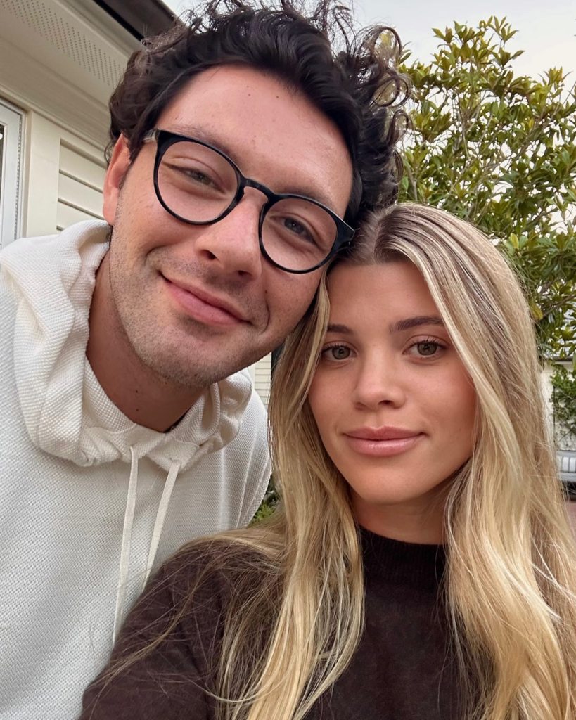 Sofia Richie and husband Elliot Grainge smiling.