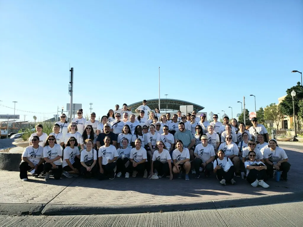 Group photo of Young Center for Immigrant Children's Rights staff wearing white t-shirts.