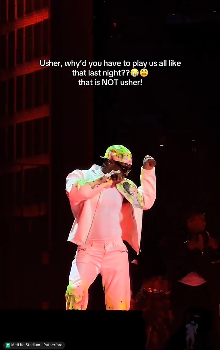 A performer in a white outfit with colorful splatters and a matching cap, singing into a microphone on stage, with overlaid text asking 